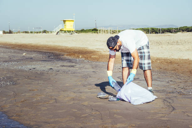 istock volunteer collecting waste that pollute the ocean 1165737300