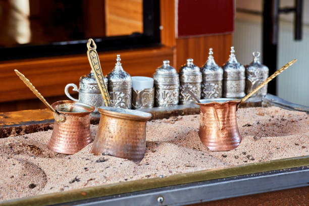 Traditional Turkish coffee cooked in hot sand and three copper cezve