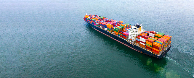 Aerial view of a fully loaded container ship in the blue sea