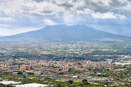 Looking at the modern city of Pompei with Mount Vesuvius in the background.