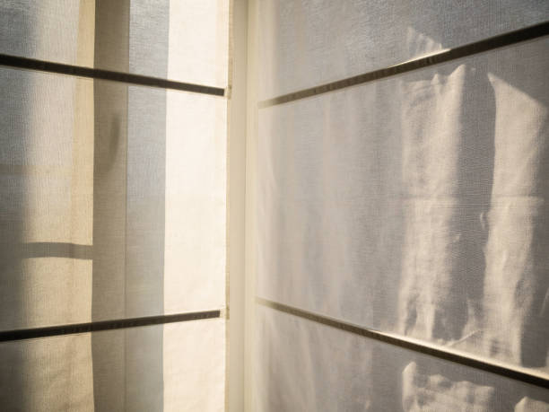 istock The closed Roman curtains. Curtains through which there passes sunlight 1165740888