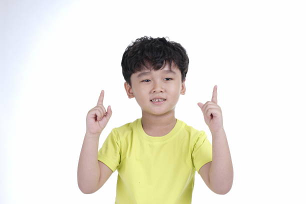 istock Asian little cute boy pointing something, isolated on white background 1165742320