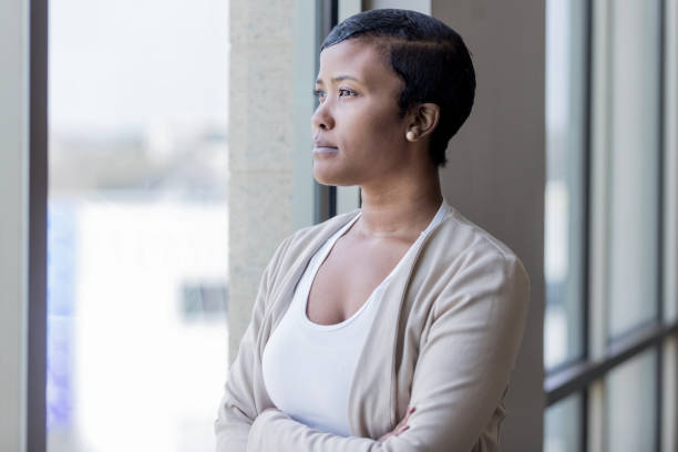 istock Young powerful woman gazes confidently out window 1165742841