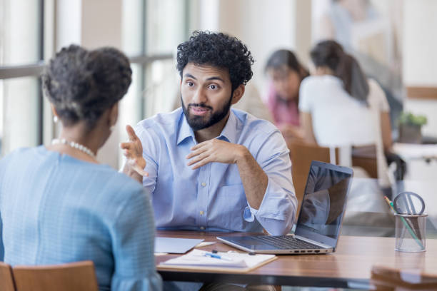 istock Financial counselor gestures while answering client's questions 1165742847