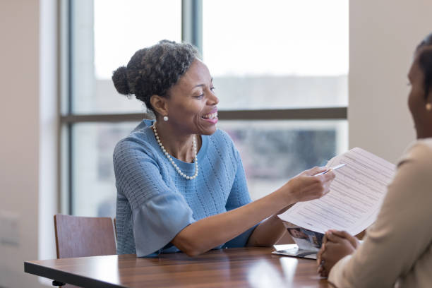 istock Personal banker persuades client to fill out application 1165742855