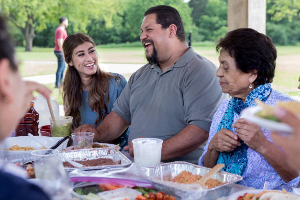 Cheerful man talks with relatives during family reunion