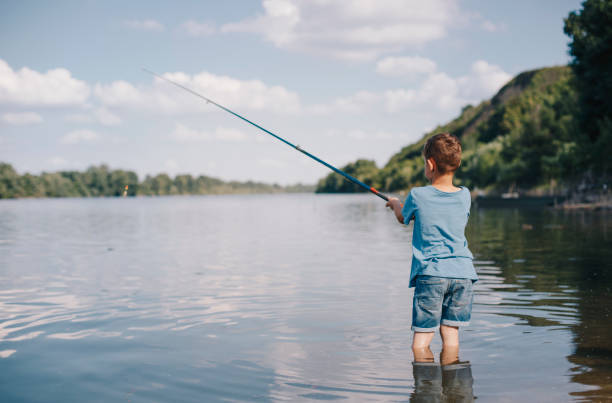istock Young boy fishing on the river 1165743866