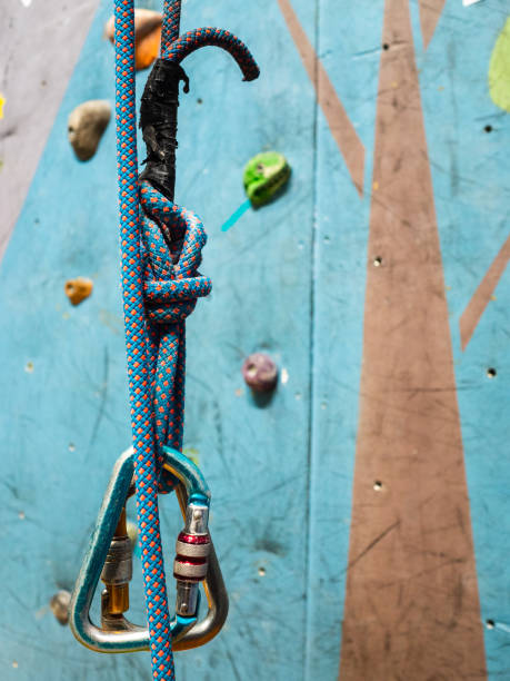 istock Carabiner and a strong rope in training for climbing. Climbing wall with obstacles 1165745597