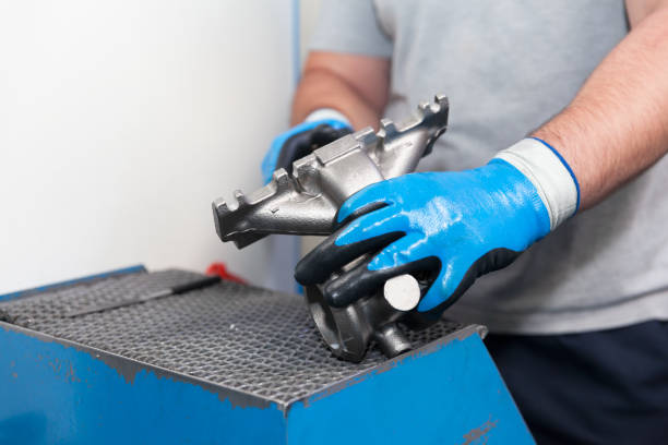 istock Automotive worker holding new part of car engine 1165746812