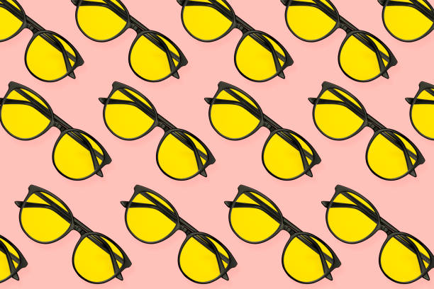 istock Top view sunglasses pattern on pastel pink, coral background. Minimal summer concept 1165754493