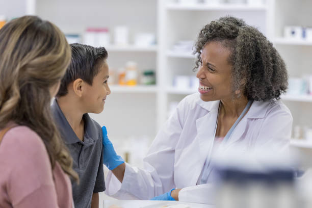 istock Pharmacist helps young boy feel comfortable before vaccine 1165754726