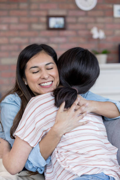 istock Mom and unrecognizable teen hug joyfully. 1165754823