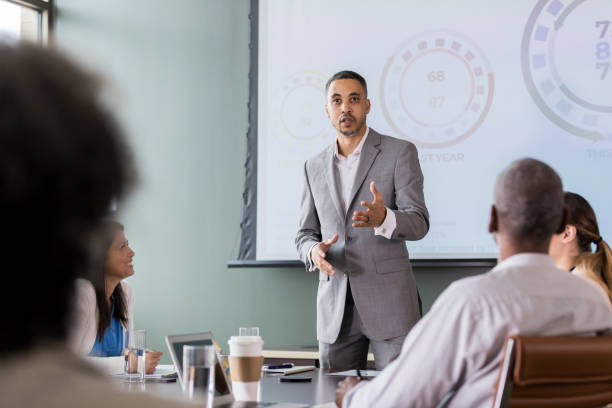 istock Man giving business presentation 1165754886