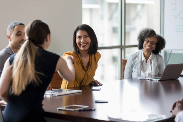 istock Confident businesspeople greet one another 1165754933
