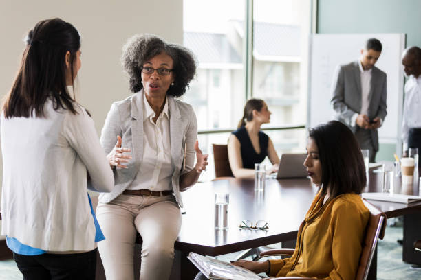 istock Businesswomen brainstorm ideas together 1165754935