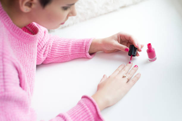 istock Woman painting her nails 1165756334