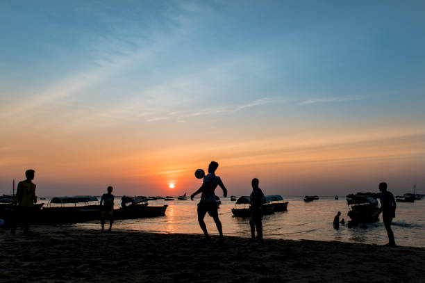 Silhouette at sunset in Zanzibar with boats on Indian Ocean stock photo