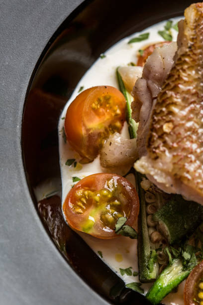 istock Fried fish accompanied by keabos and tomatoes seen from above. Gourmet dish. 1165758477