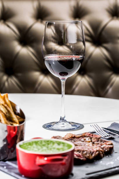 Gorgeous roast beef served with chips and a pan of asparagus with a glass of wine. Gorgeous roast beef served with chips and a pan of asparagus with a glass of wine. blade roast stock pictures, royalty-free photos & images