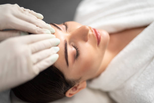 istock Beautiful young woman is receiving face massage 1165760663
