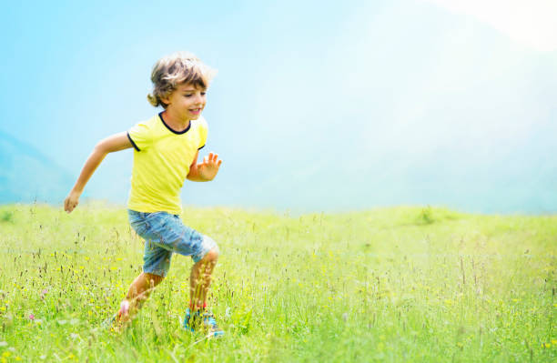 istock Blond Hair Boy Running on the Meadow 1165762285