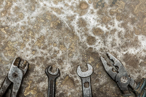 istock old worn tool on rumpled shabby metal, close-up abstract background 1165765304