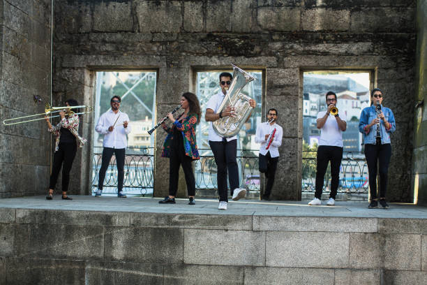 istock Jazz musicians with wind instruments playing on the street. 1165767028