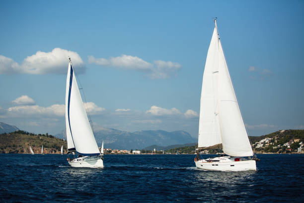 istock Sailing ship yachts with white sails in the open sea. 1165767030
