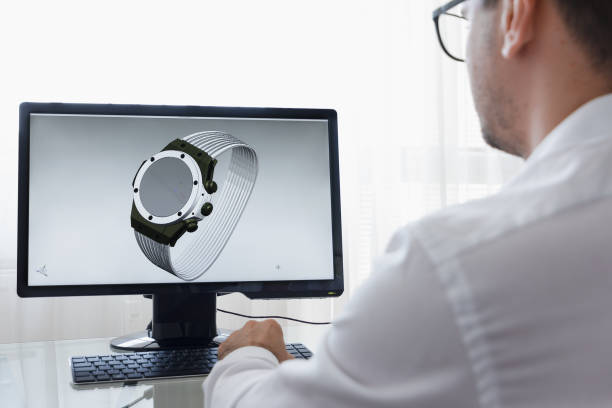 istock LOS ANGELES, CALIFORNIA - JUNE 3, 2019: Engineer, Constructor, Designer, Architect in Glasses Working on a Personal Computer. He Creating New Design of Smart Watch in CAD Program. Freelance Work. An illustrative editorial image 1165770246