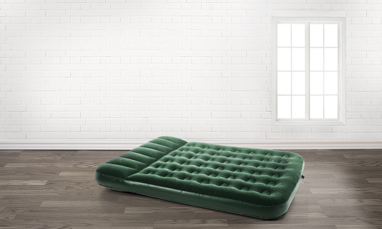 inflatable mattress in an empty room