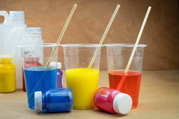 istock Mixing color epoxy resin in plastic cup for casting Stabilizing wood and pine cone hybrid 1165772788