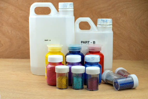 istock Mixing color epoxy resin in plastic cup for casting Stabilizing wood and pine cone hybrid 1165772859