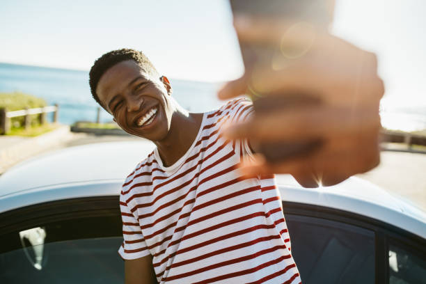 istock African guy making a selfie outdoors 1165772876