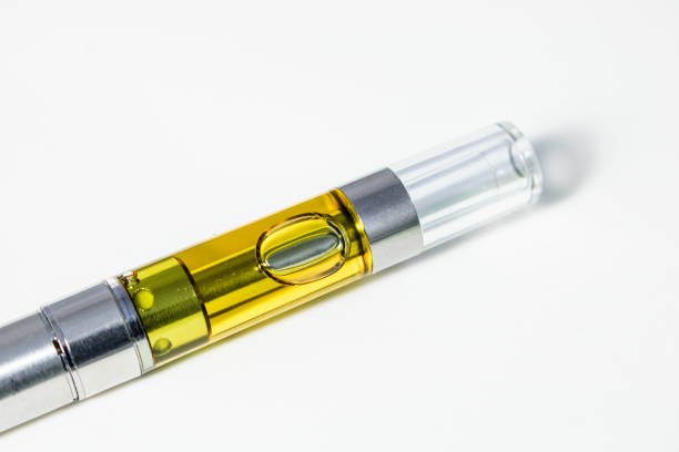 Vape Pen Isolated Up Close - THC & CBD Cannabinoids Concentrated Into Oil Liquid Extract Full gram cartridge of cannabis oil extract and terpenes. Marijuana vape pen is an alternative method of smoking and consuming  marijuana. rosin stock pictures, royalty-free photos & images