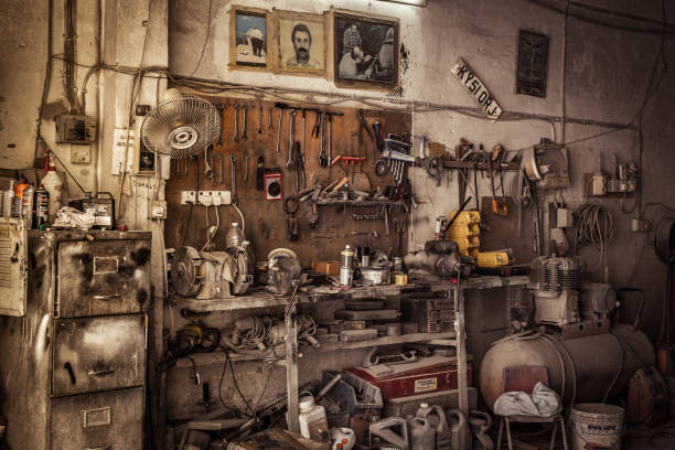 Old dusty mechanics workshop with old tools covered by dust stock photo