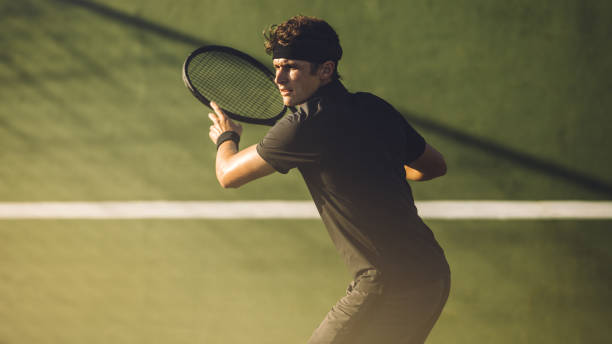 istock Young player playing tennis on hard court 1165773987