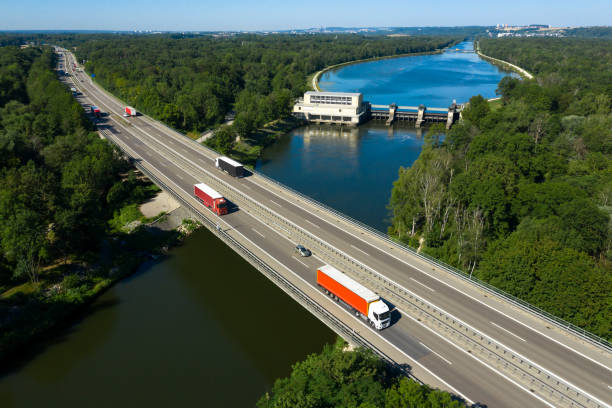 istock Semi Trucks on Highway Bridge, Aerial View 1165775086
