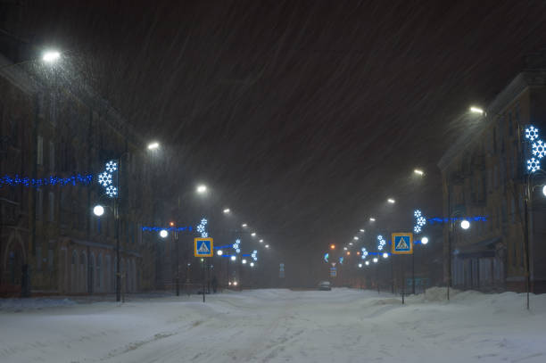 istock Winter landscape with snowstorm in city 1165777701