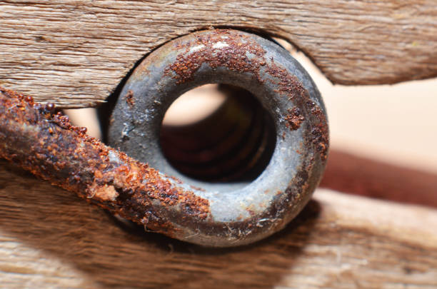 Used components made of iron that has been rusty for a long time in brown with black spots mixed with brown and yellow and uneven in shape\