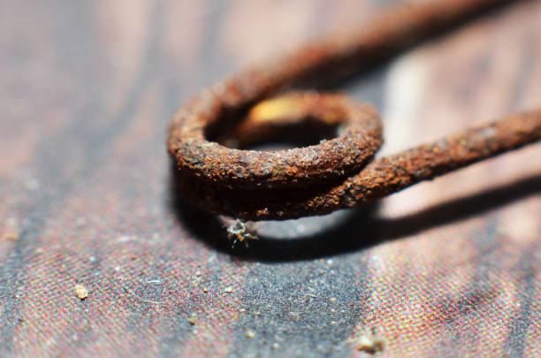 Used components made of iron that has been rusty for a long time in brown with black spots mixed with brown and yellow and uneven in shape\