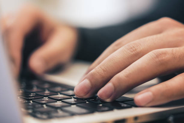 istock Sideview of male using laptop on table 1165783678