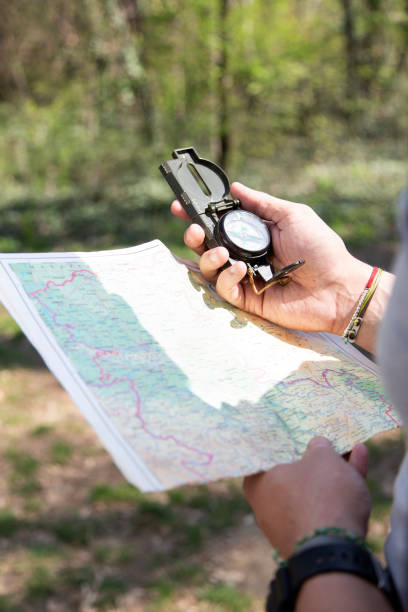 istock Male hiker using a map to locate the destination 1165783780