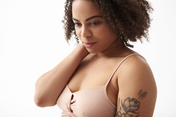 istock Upset Afro American female with tattoo on arm posing for camera 1165783793