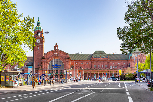 Wiesbaden, Germany - April 10, 2011: facade of famous classsicistic old train station in Wiesbaden with people