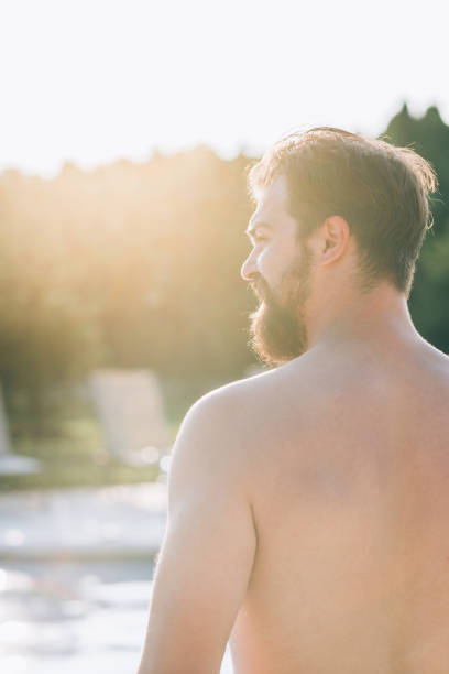 istock Millennial man  at the outdoor pool 1165791655