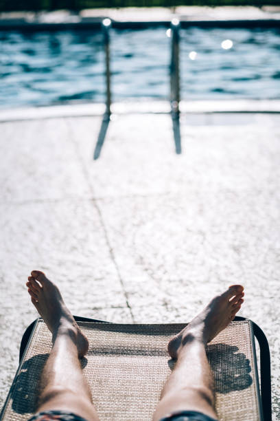 istock Millennial man  at the outdoor pool 1165791824