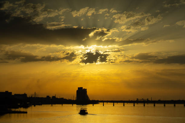 istock Vibrant sunset under the Dnipro river with city silhouettes 1165793538
