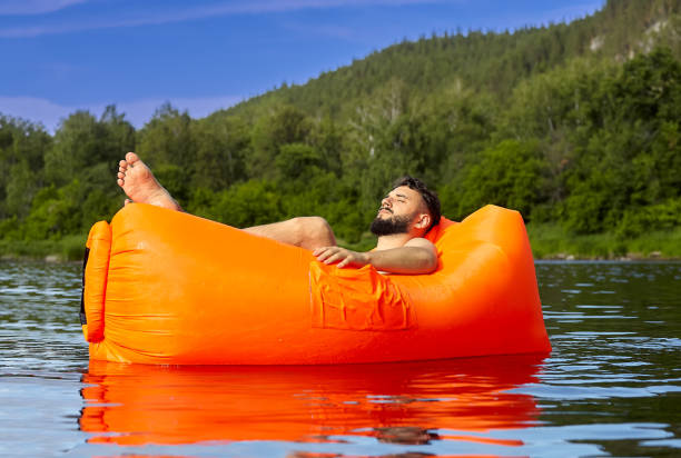 istock Ecotourism with lying on air sofa. 1165797431