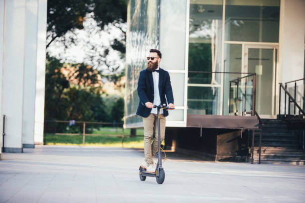 istock Hipster businessman taking an electric scooter to work 1165800158