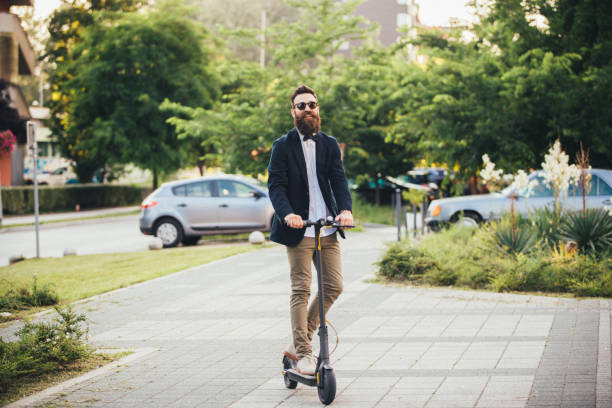istock Hipster riding an electric scooter 1165800180